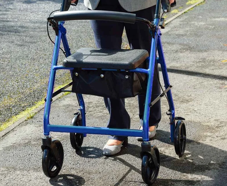 Senior walking safely with a rolling walker using best practices