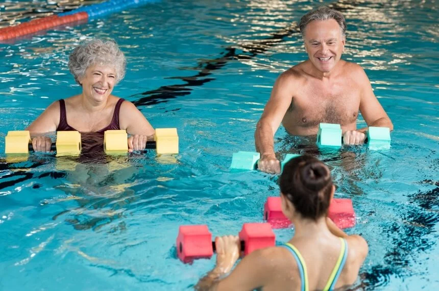 Elderly woman swimming laps in senior-friendly pool