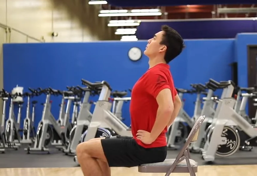 Gentle chair-based backbend for seniors to increase spinal mobility