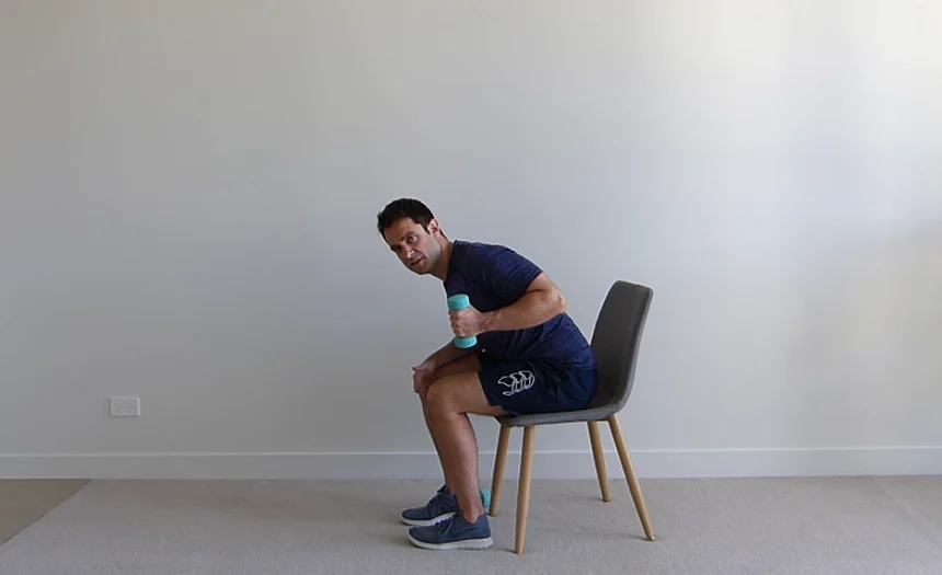 Older adult doing seated bicep curls for upper body strength