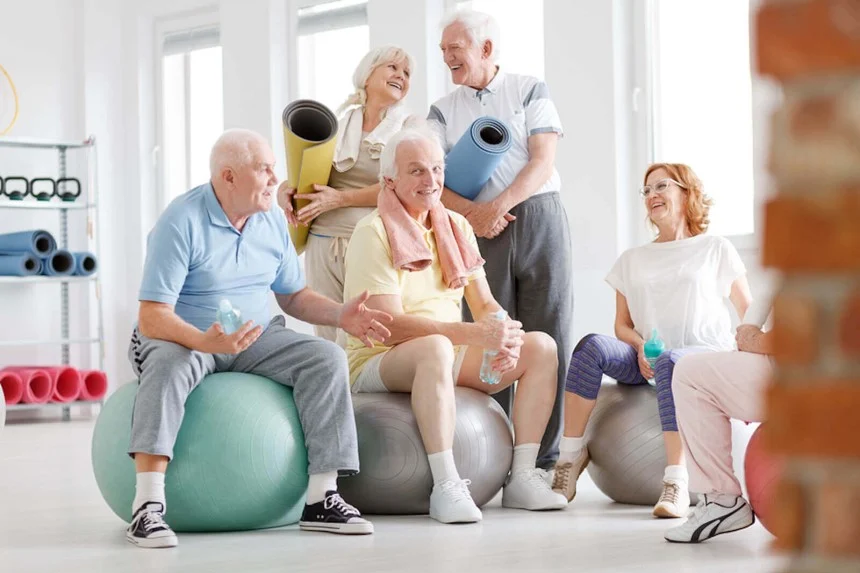 Elderly woman doing chair exercises for senior flexibility and strength