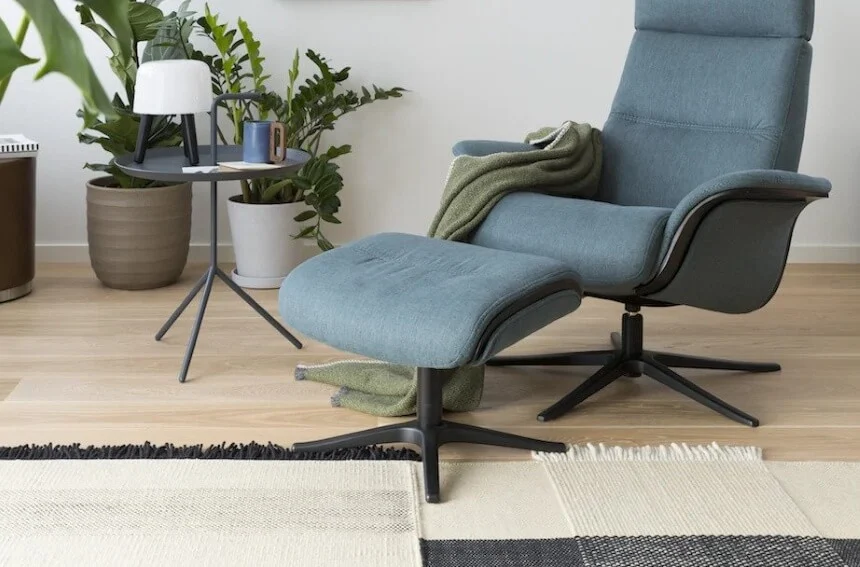 Senior resting comfortably in a recliner chair to alleviate back pain.