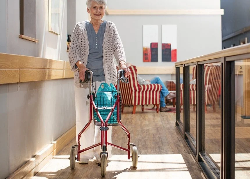 Senior testing out a 3 wheel walker for boosting stability