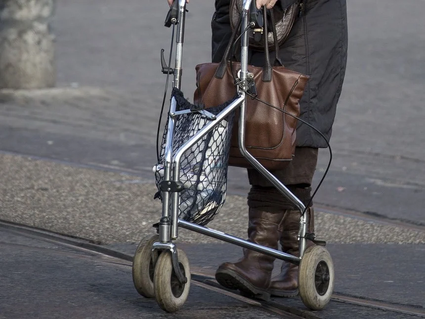 Senior person enjoying extra stability from a rollator
