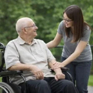 Nan J Corbo Helping Man in Wheelchair