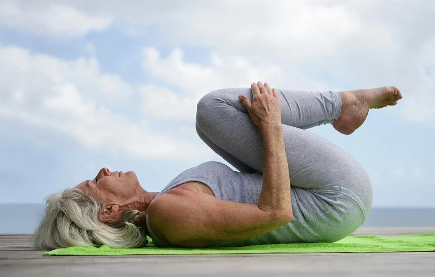 Elderly person engaging in yoga to enhance flexibility and mental clarity